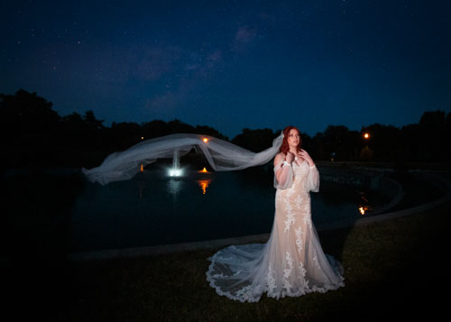 Dramatic night bridal portrait by lake - Kansas City fine art wedding photographer